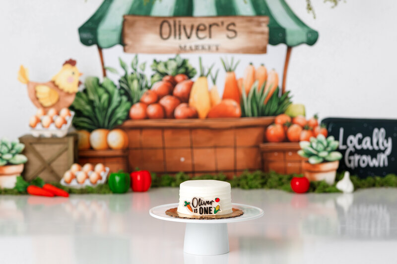 Happy Tampa baby enjoying a personalized luxury cake smash session with playful decorations