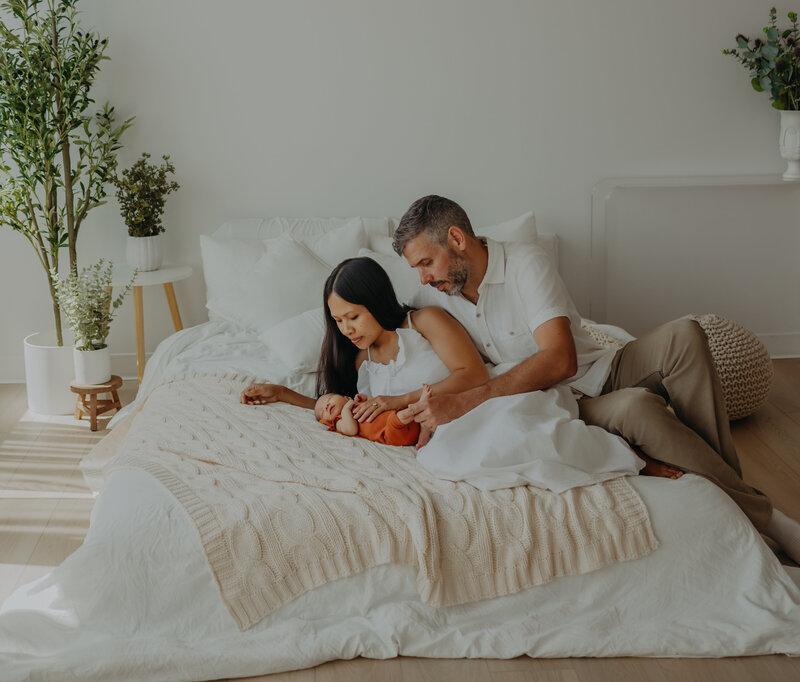 mom nurses newborn baby during photoshoot with Edmonton's best newborn photogrpapher