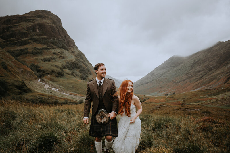 Eloping couple hiking together in Scotland's highlands