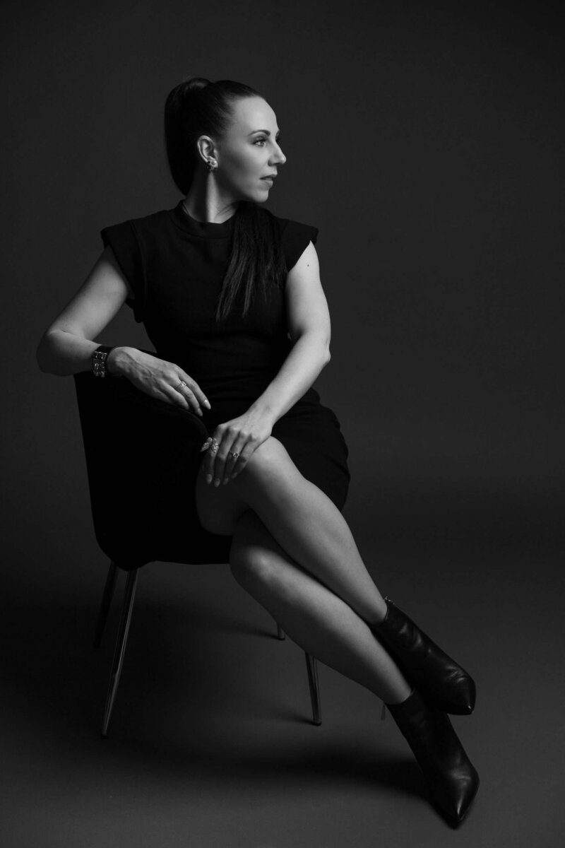 Timeless black and white photo of a woman sitting on a chair during a Langley Branding Photoshoot