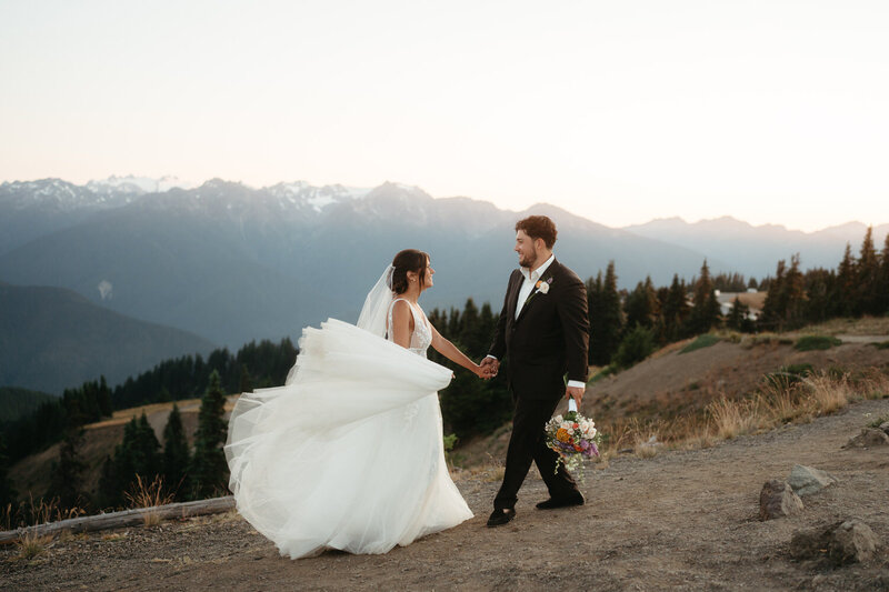 Couples walks with beautiful mountains behind them during their Olympic National Park Elopement