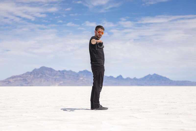 man stands with camera at the Utah salt flats