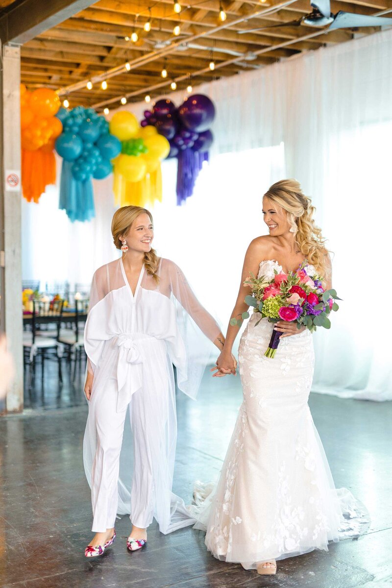 brides holding hands while walking