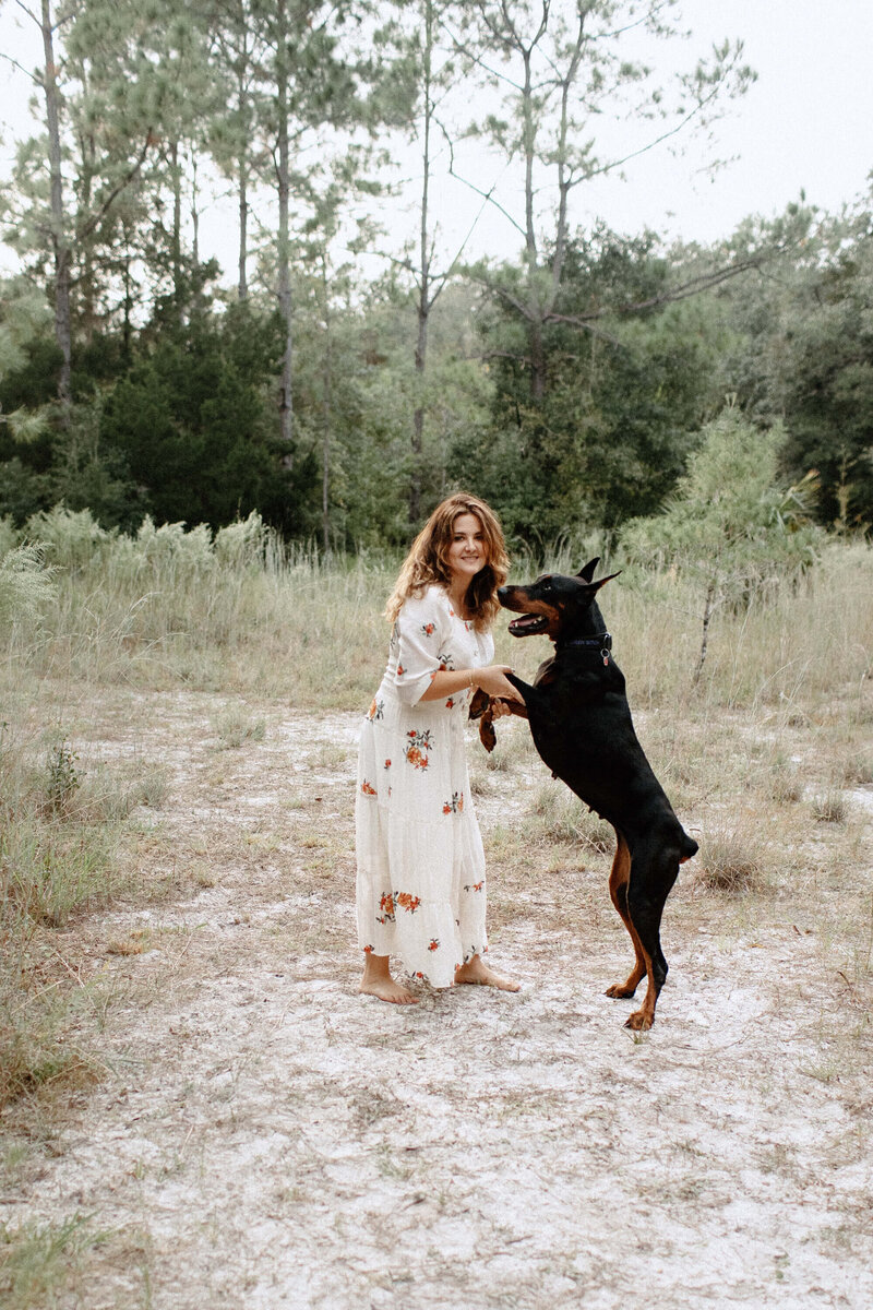 Lifestyle photography woman with dog in field inTampa Bay, Florida Nadine B Photography