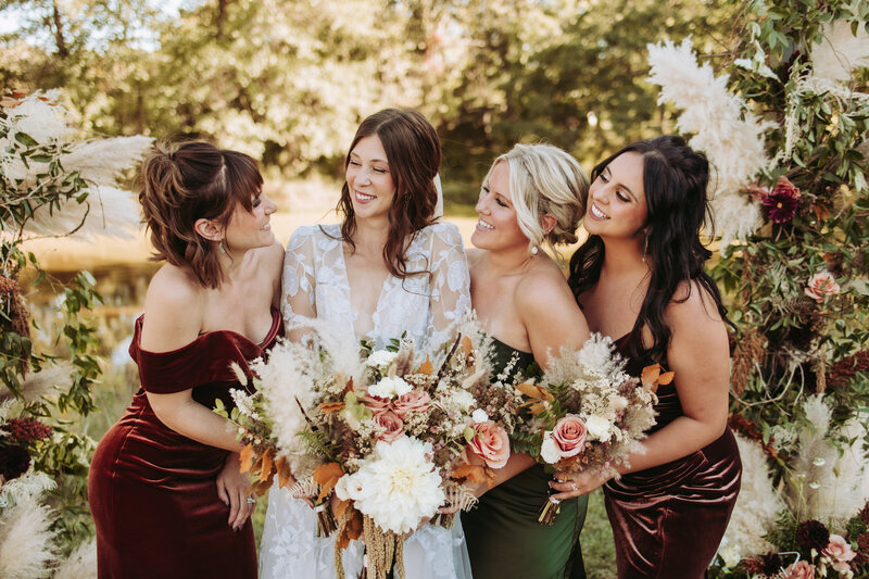bride-holding-veil-in-forest