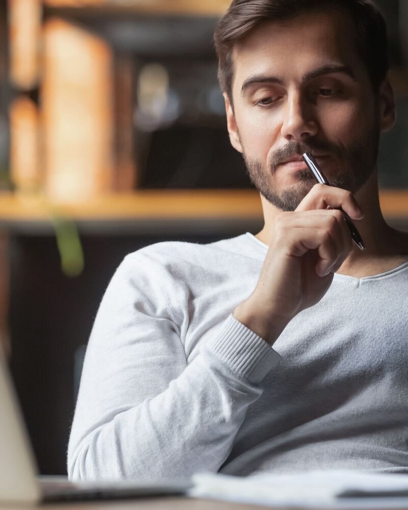 Dr. Mike engaging in an online therapy session, talking with another person on a laptop screen.