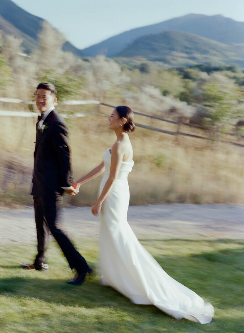 smiling bride and groom  press their foreheads together in a quiet moment
