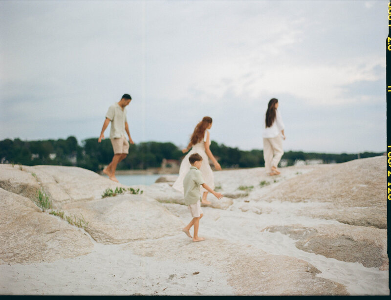 family strolls on wingaersheek beach in gloucester during family session taken by boston documentary wedding photographer