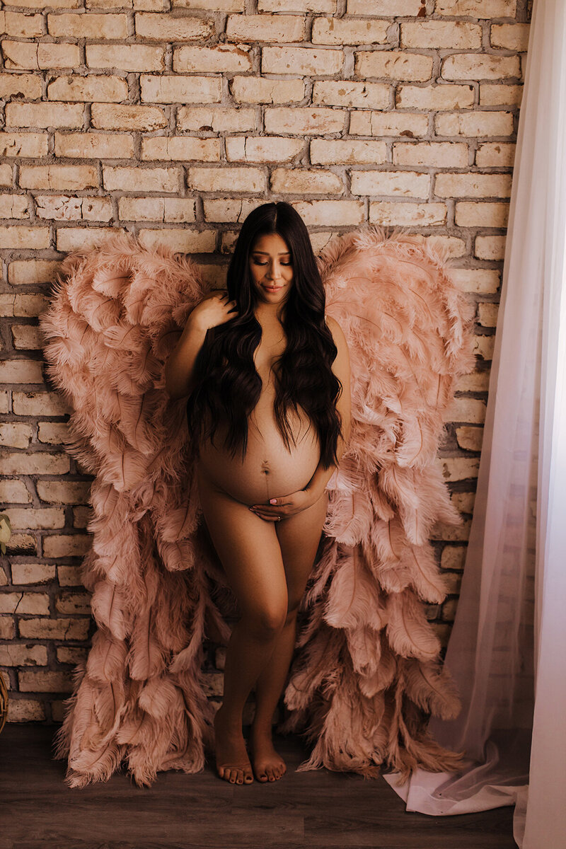 Maternity portraits with angel wings in phoenix maternity studio