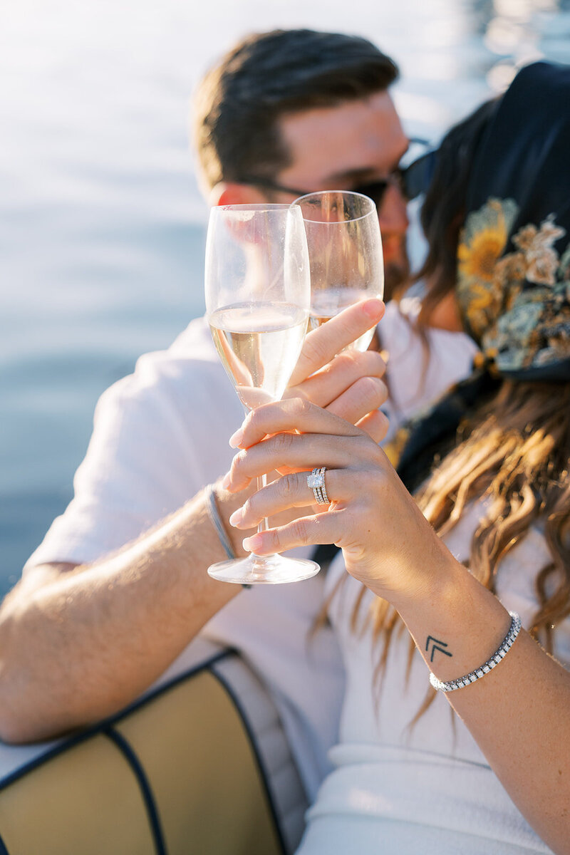 Man and woman doing cheers with champagne after their engagement