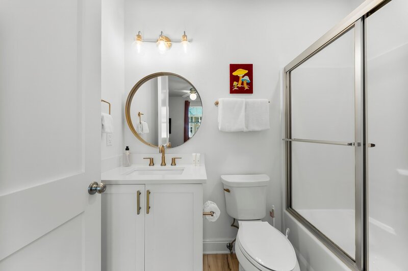 Ensuite bathroom with mushroom wall art and gold hardware in Groovy Shack, a unique Panama City Beach rental close to Carillon and 30A.