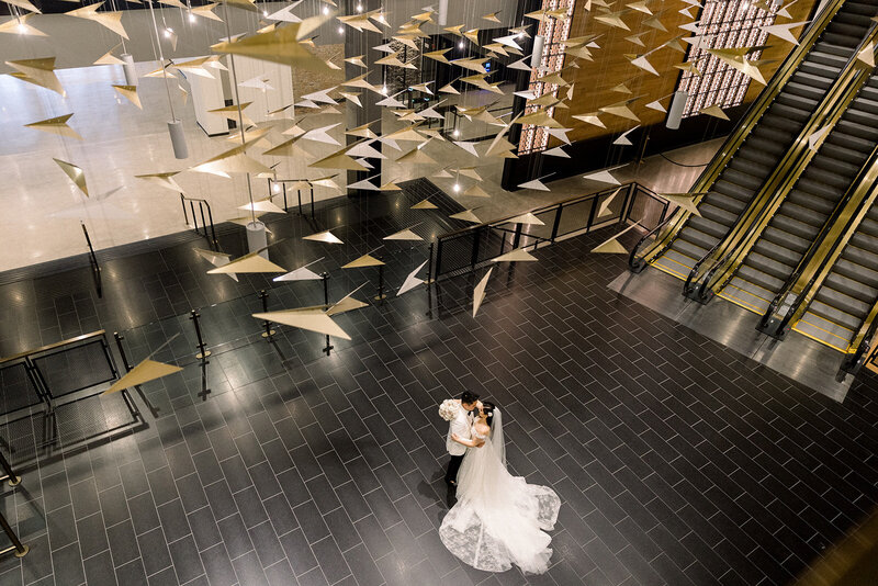 bride and groom dancing under paper airplanes