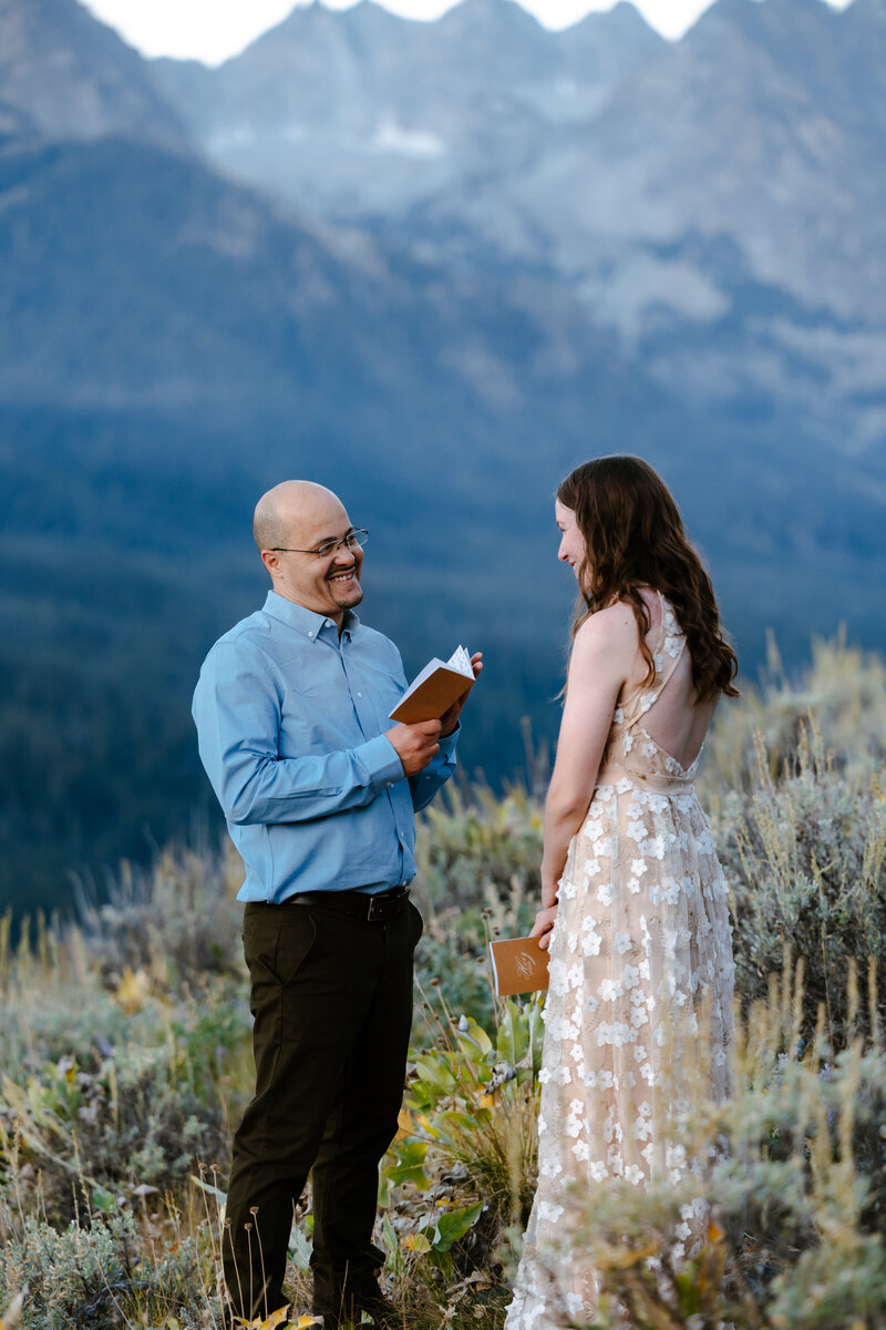 A couple looking into each others eyes laughing in the Sawtooth mountains in Stanley, Idaho