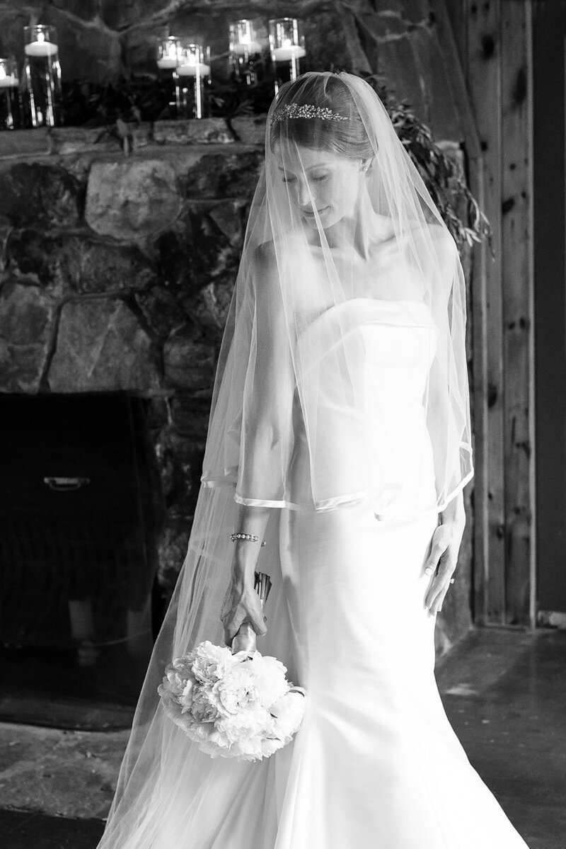 bridal portrait in black and white with veil over her face during her wedding in lake george