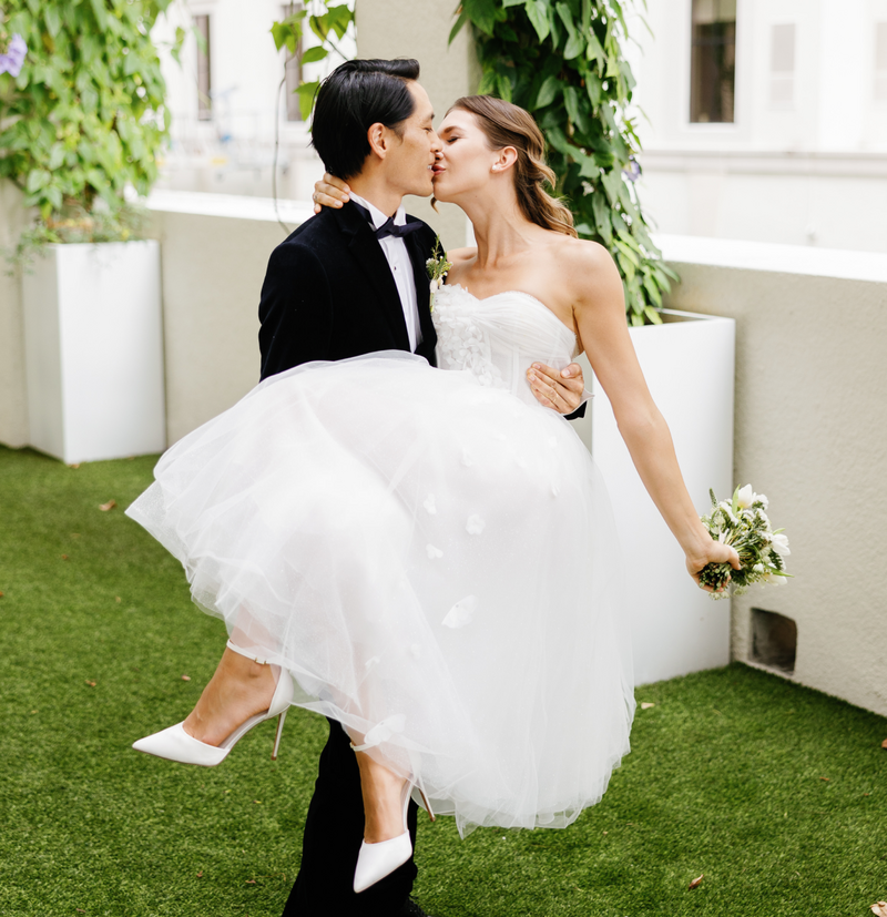 Bride and groom share a kiss while the groom lifts the bride, captured by Claudia Amalia, a wedding and lifestyle photographer based in Miami, Florida. Specializing in destination weddings in South Florida and the Florida Keys.