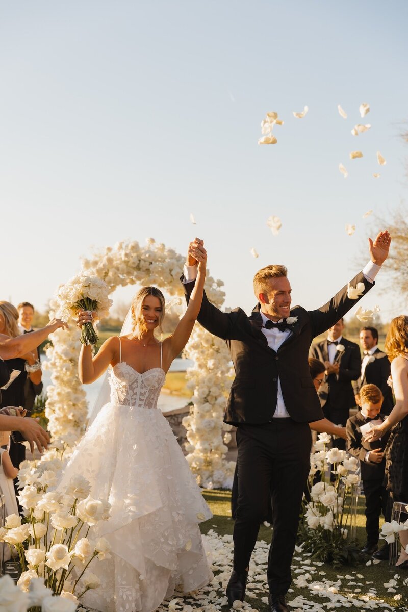 bride and groom exit wedding ceremony in arizona