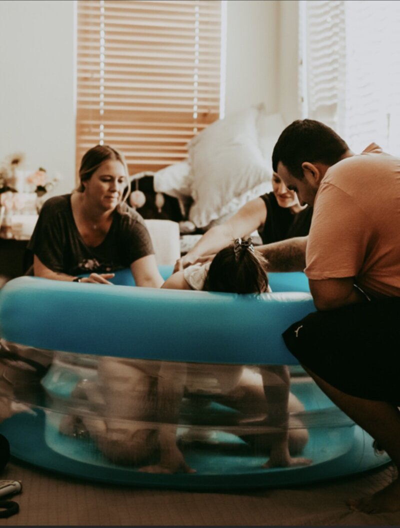 Doula support in water tub  Cherry Blossom Doula Photography