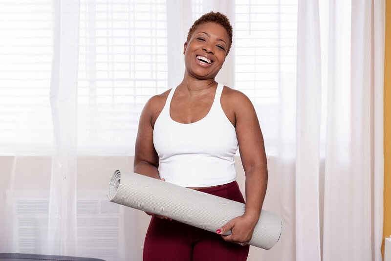 Michelle carrying a yoga mat