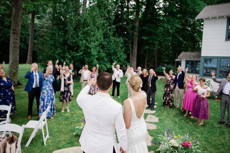 Bride and groom standing in wildflowers in Colorado wedding