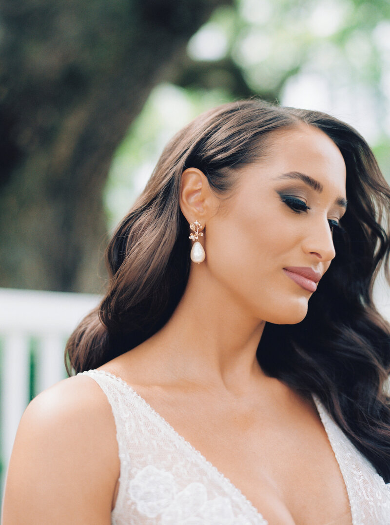 Dark haired bride with pearl earring. Spring wedding in Charleston.