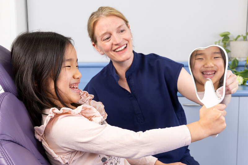 Dentist and patient laughing together