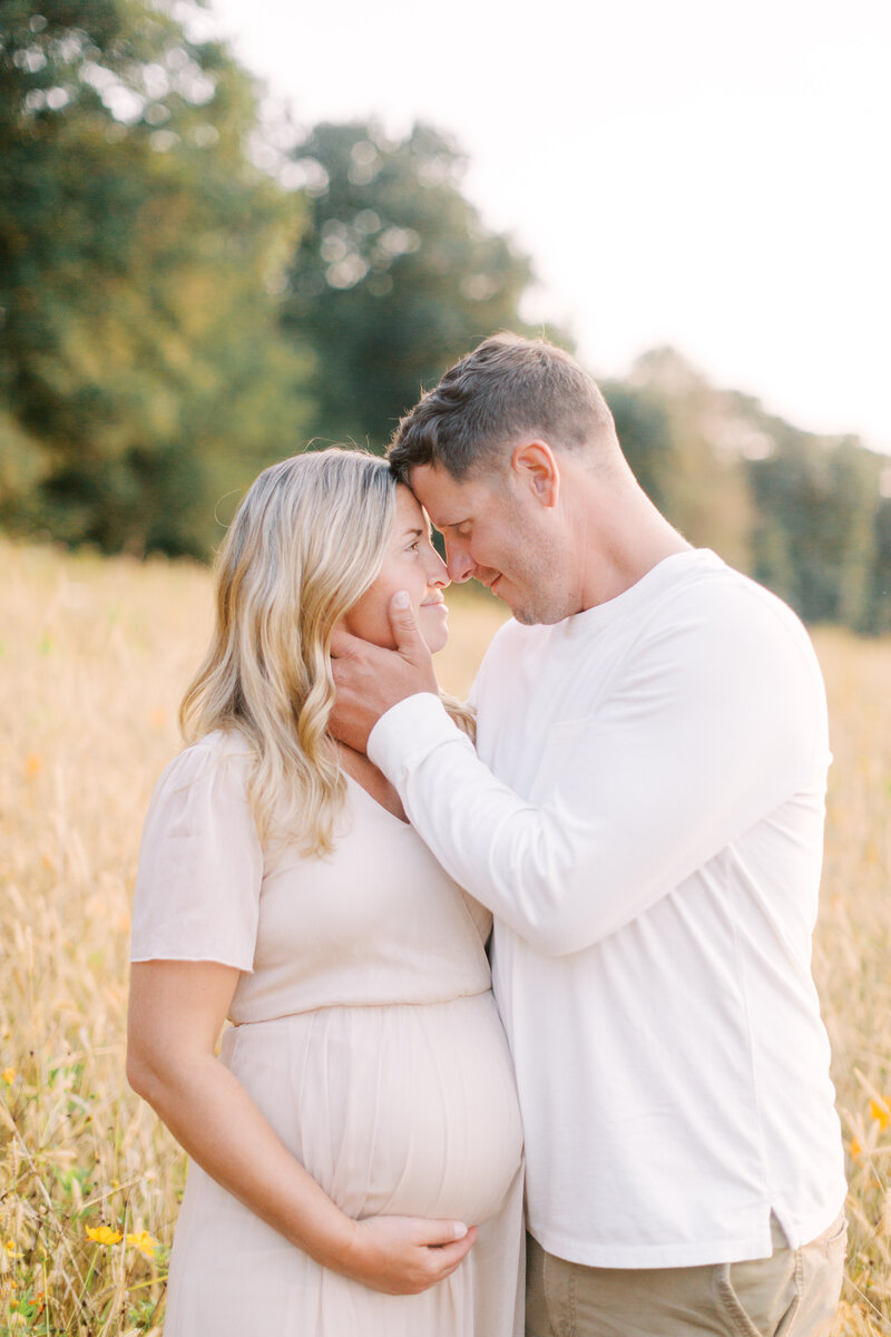 Couple at maternity session in flower field