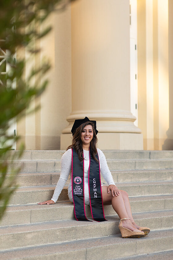 PhD grad smiling on campus at Chapman University