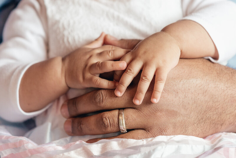 baby-girl-holding-fathers-hand