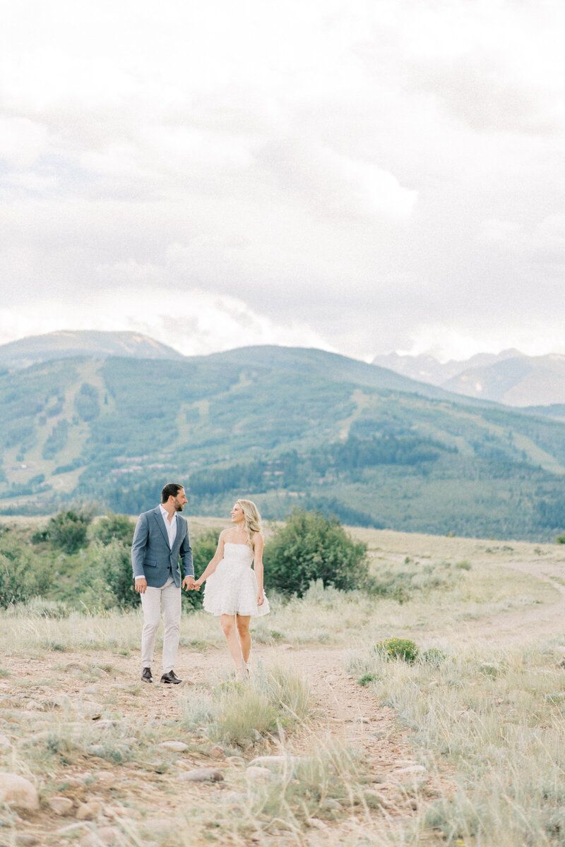 This cute couple kisses in front of their Aspen Colorado engagement photographer.