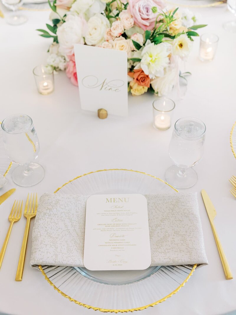 gold table setting at wedding reception