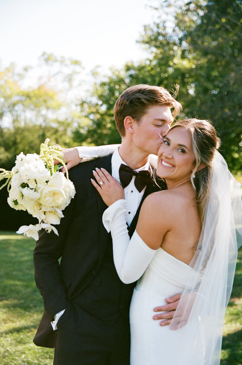 Artistic photo of a couple on their wedding day with a bouquet