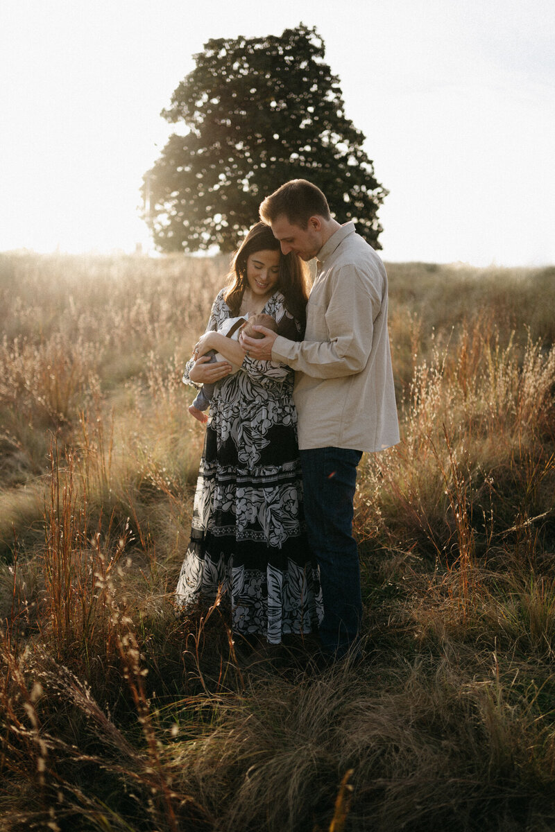 family photography in tall grass with newborn