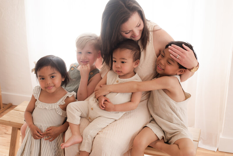 A mother holding her four children in Hope Louise's studio.
