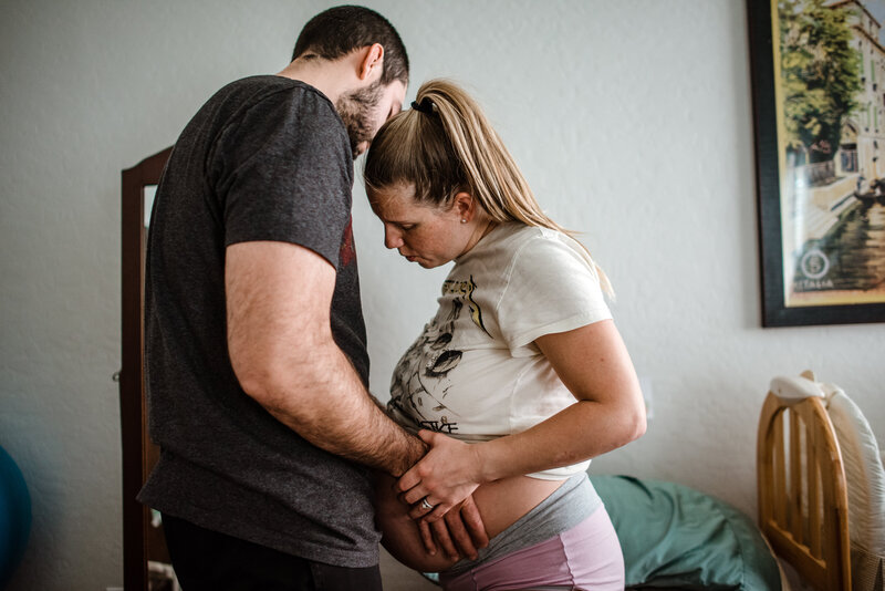 Pregnant woman in labor holding hands with a man