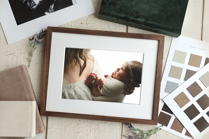 Framed portrait laying with other wall art examples of newborn baby girl