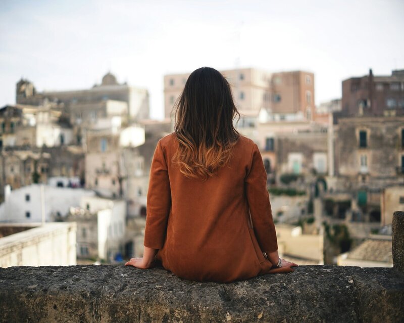 women sitting on a wall in matera italy