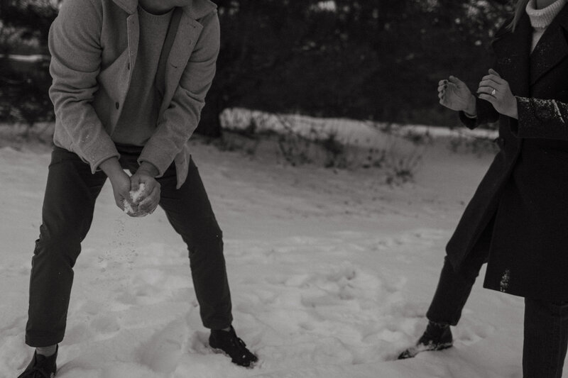 couple has a snowball fight