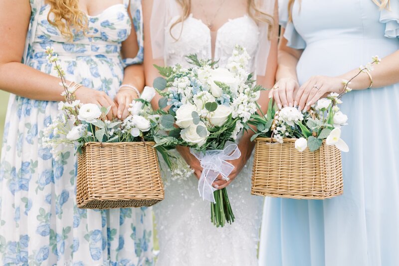 bride and bridesmaids holding flower baskets