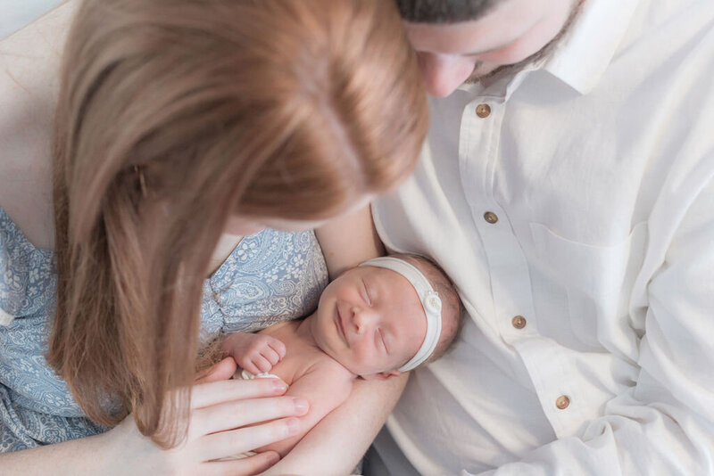 Parents snuggling newborn in Savannah GA photography session
