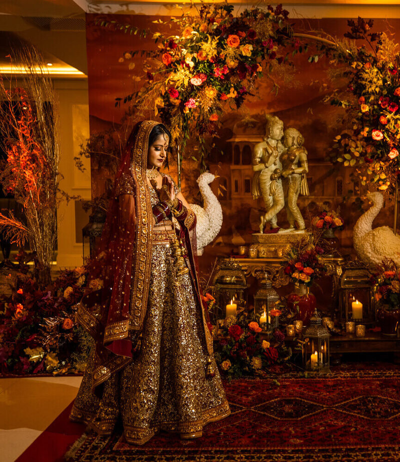 A stunning bride praying in the lobby of the Fairmont Windsor Ballroom in front of a beautiful foyer display