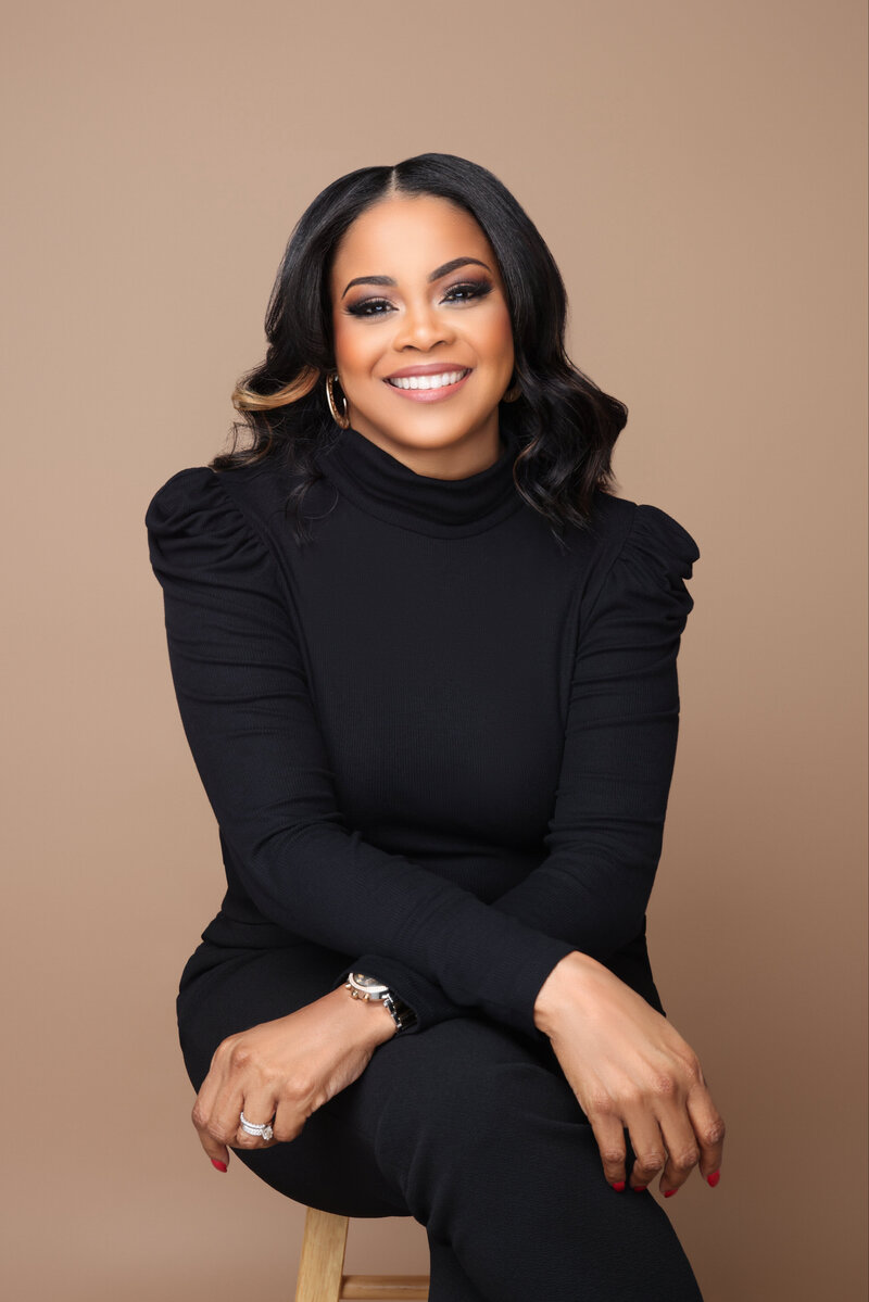 Angela smiling in a black turtleneck