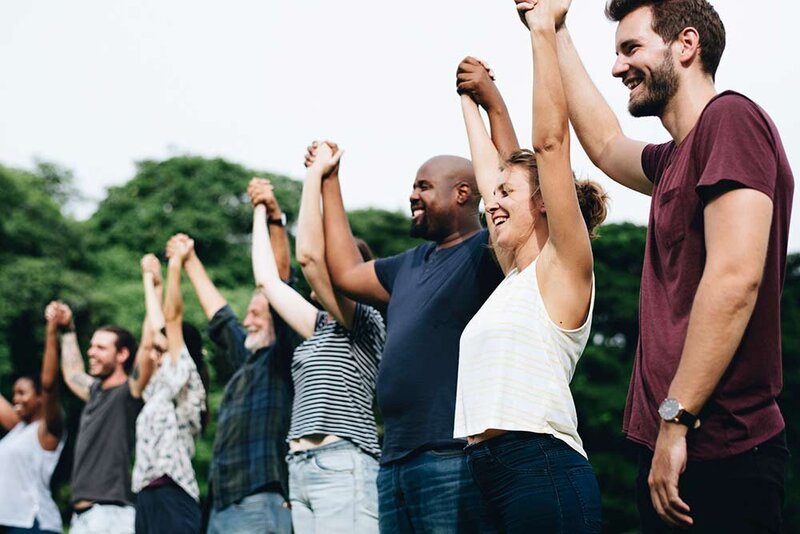 Image of people holding hands and smiling