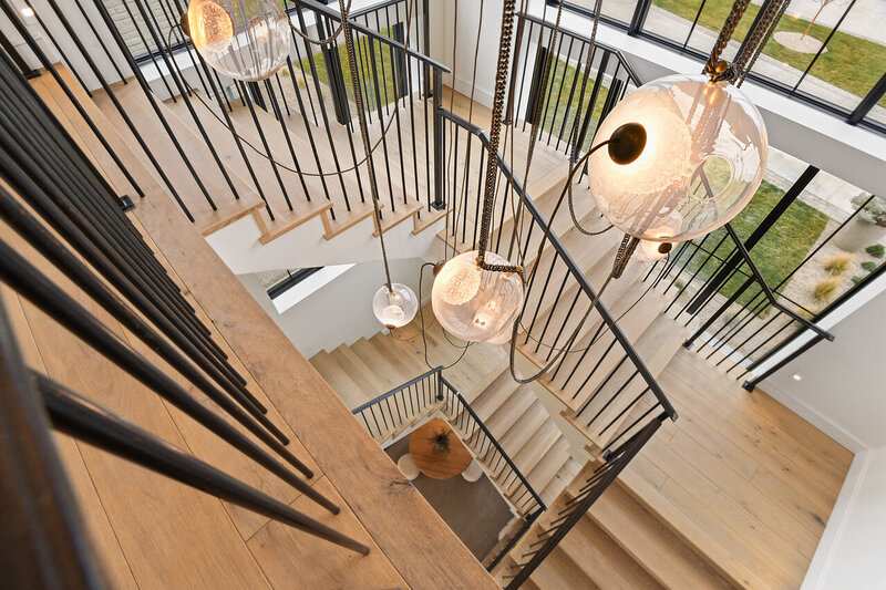 luxury staircase and statement lighting by Eagle Idaho luxury custom home builder and interior designer Thompson Homes
