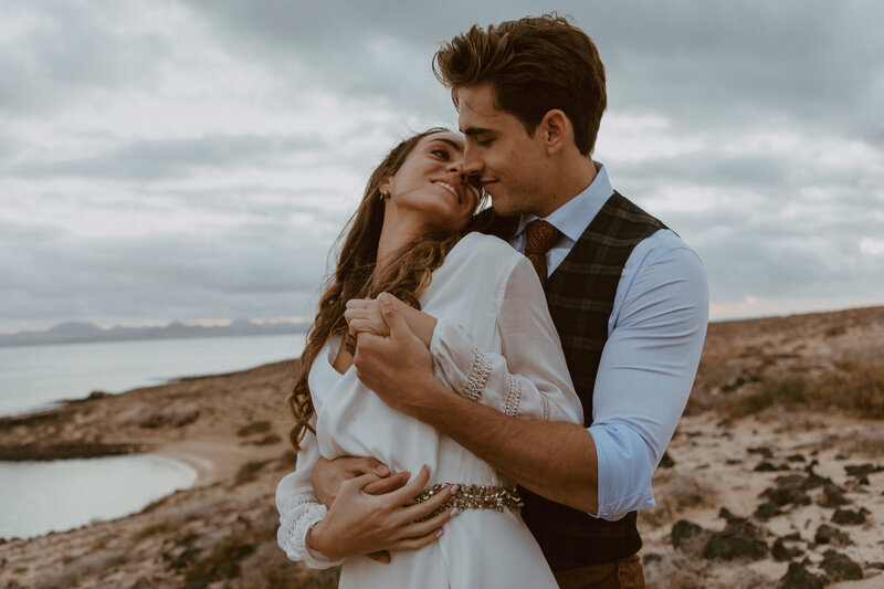 Man and woman embracing on beach