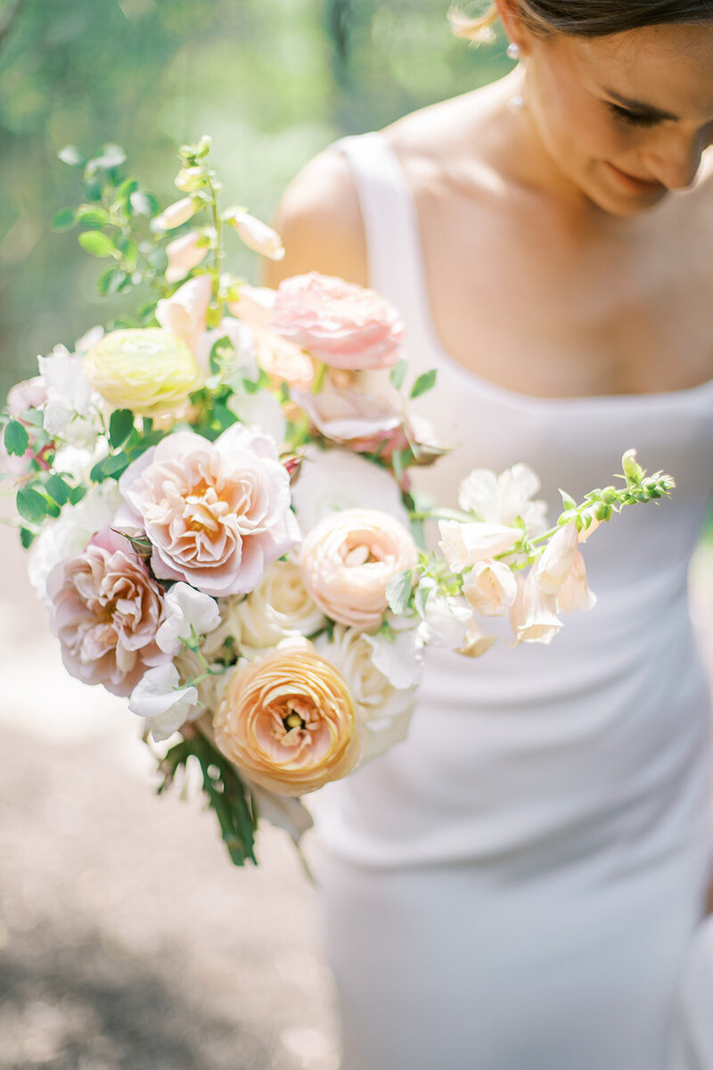 Apricot, peach, blush, white, pale yellow organic bridal bouquet with roses, ranunculus, snapdragons, spirea