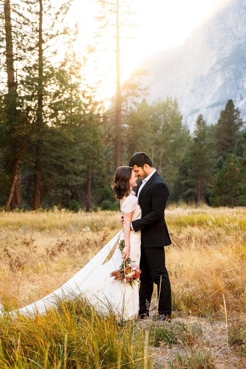 An eloping couple stares into each other's eyes at sunset in Yosemite.