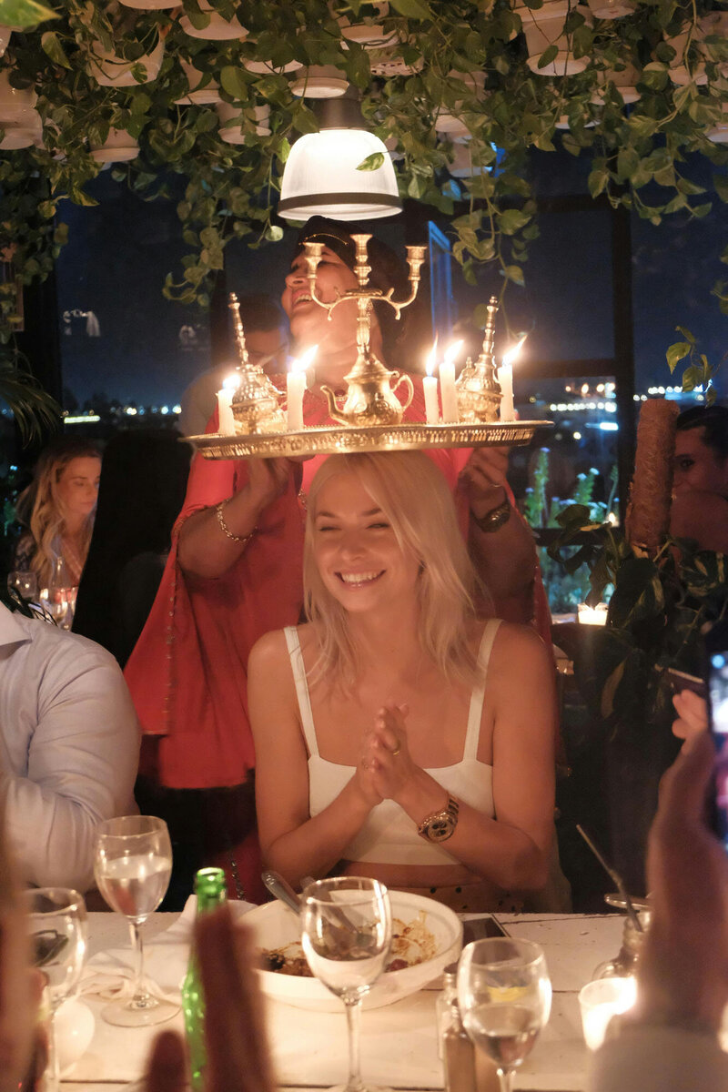 Woman holds a tray of candles over her head