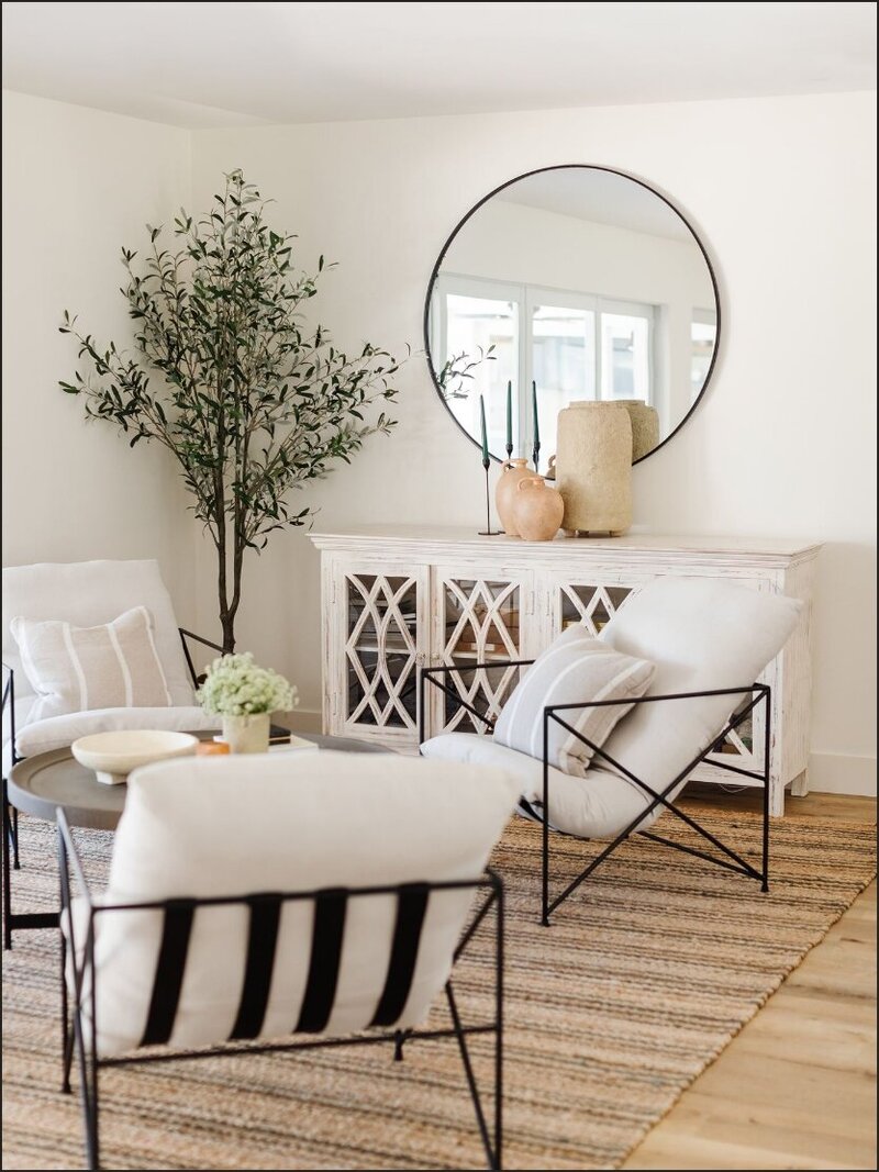 Living room with white chairs and white console table