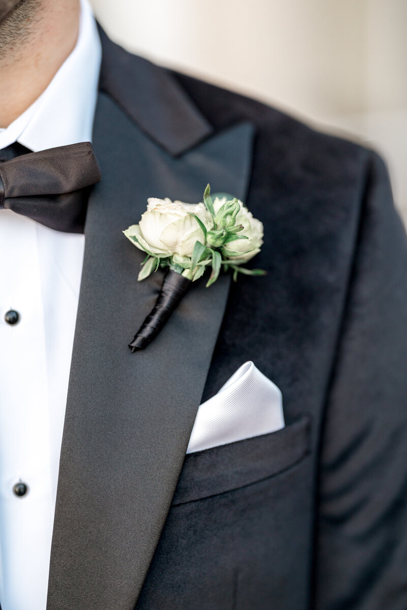A close up of a grooms boutonniere at Blithewold Mansion
