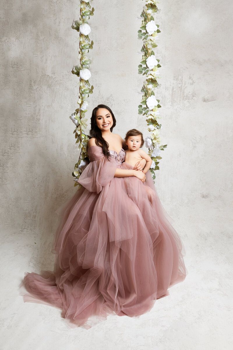 Maternity family session kids running around mom in open field